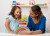Therapy Assistant & Young Girl Rainbow Blocks